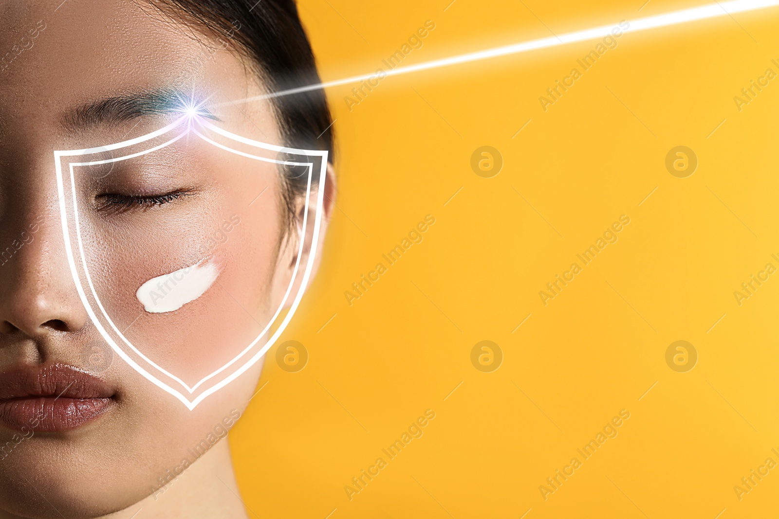 Image of Sun protection care. Beautiful woman with sunscreen on face against golden background, space for text. Illustration of shield as SPF