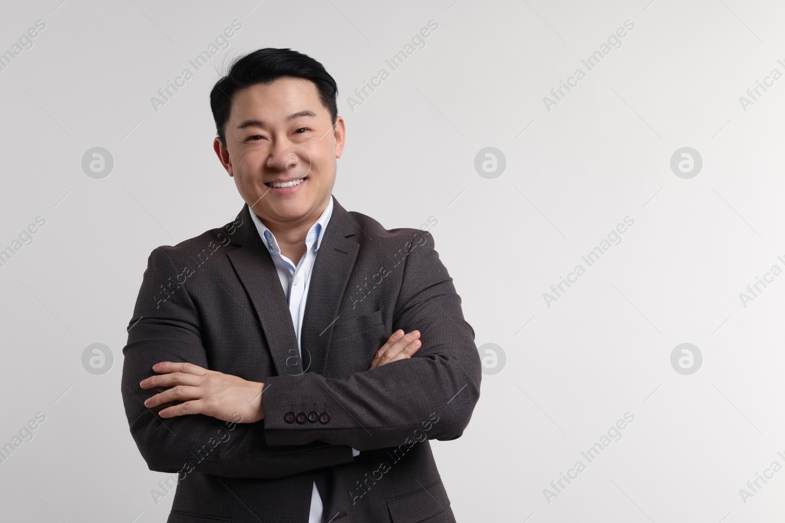 Photo of Portrait of happy man on light background. Space for text