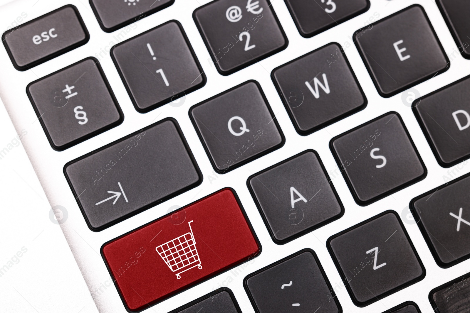 Image of Internet store. Red button with shopping cart on computer keyboard, top view