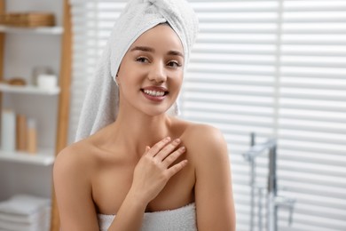 Photo of Portrait of smiling woman after shower in bathroom