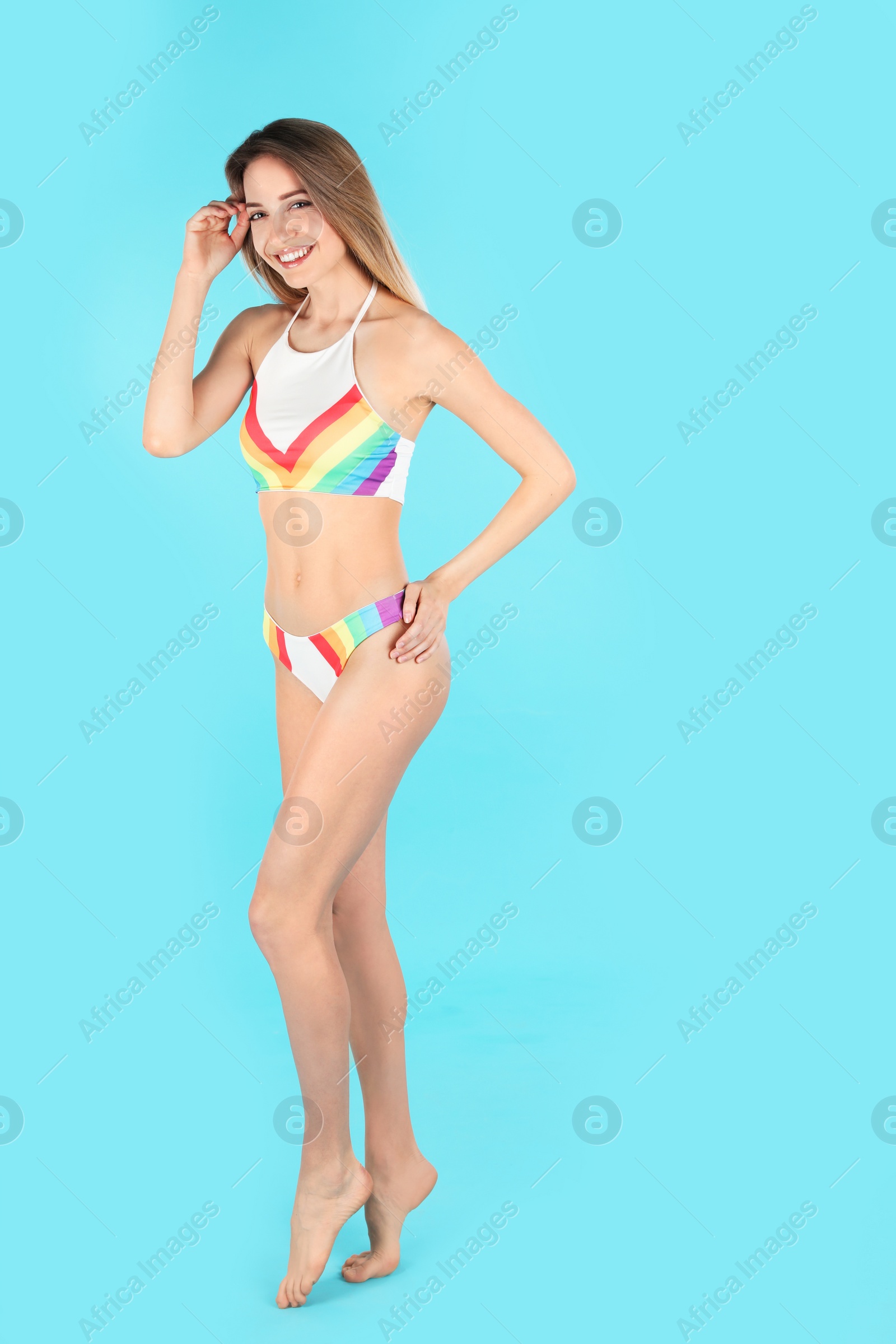 Photo of Young slim woman in bikini on color background, space for text. Perfect body