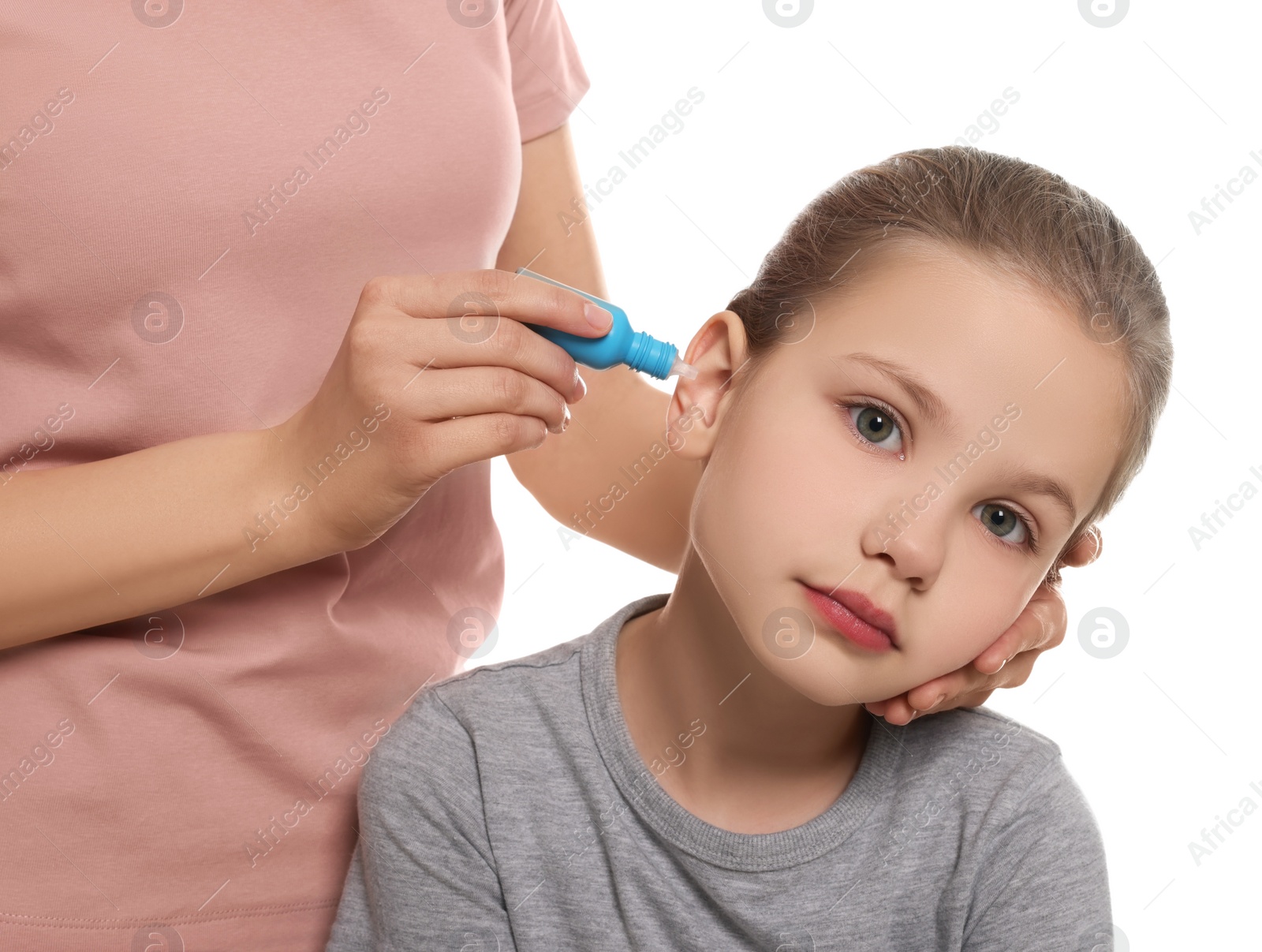 Photo of Mother dripping medication into daughter's ear on white background