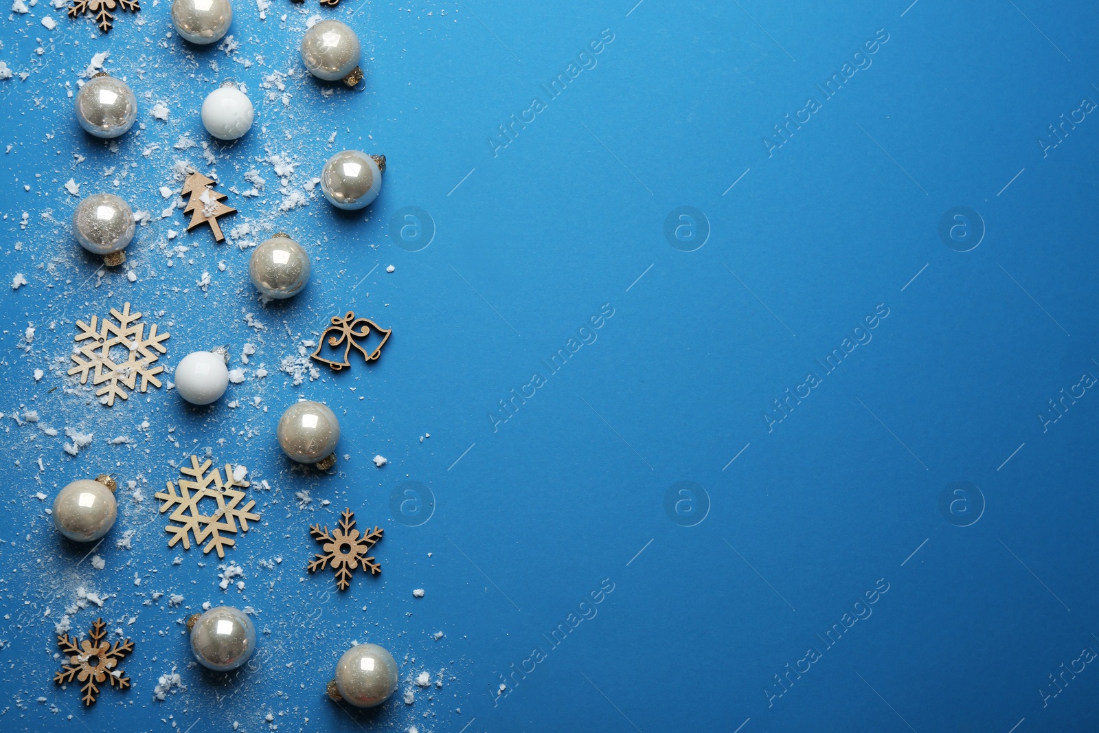 Photo of Flat lay composition with Christmas decorations on blue background, space for text. Winter season
