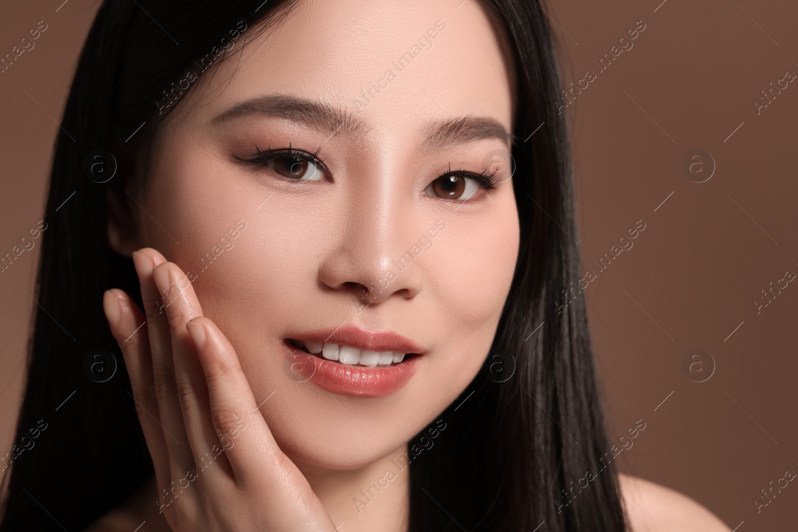 Photo of Portrait of beautiful woman on brown background, closeup