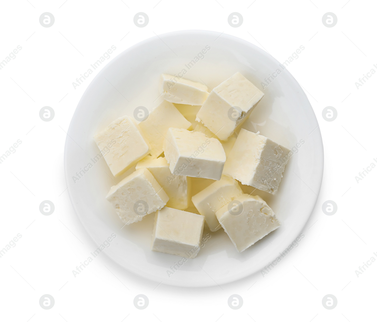 Photo of Plate with cubes of tasty fresh butter on white background, top view