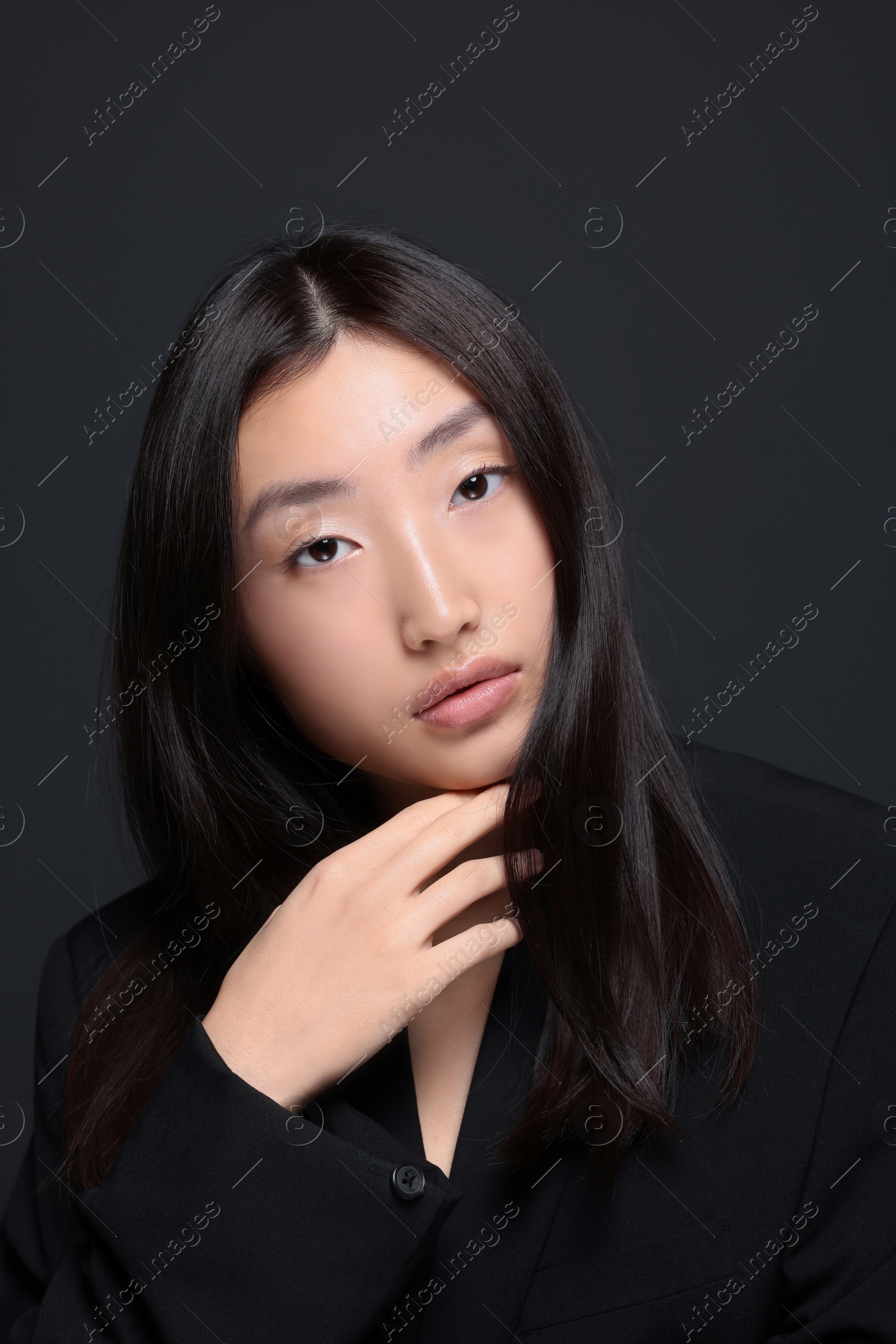 Photo of Portrait of beautiful young Asian woman on black background