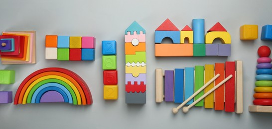 Different children's toys on light grey background, flat lay