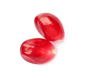 Photo of Tasty pomegranate seeds on white background, top view