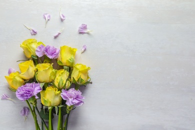 Photo of Flat lay composition with beautiful blooming flowers on light background