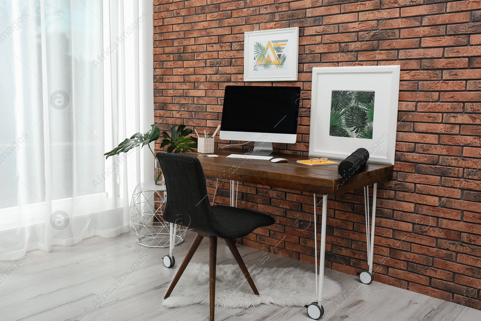 Photo of Interior of stylish workplace with modern computer at home