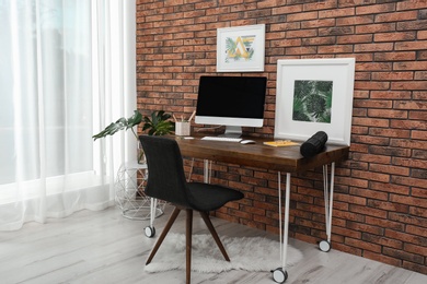 Interior of stylish workplace with modern computer at home