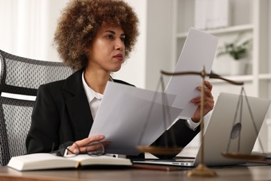 Photo of Notary working with documents at workplace in office