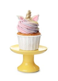 Photo of Yellow dessert stand with cute sweet unicorn cupcake isolated on white