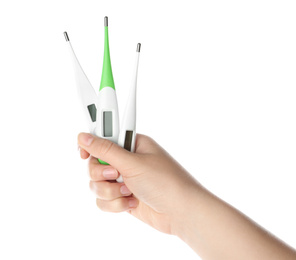 Woman holding different thermometers on white background, closeup