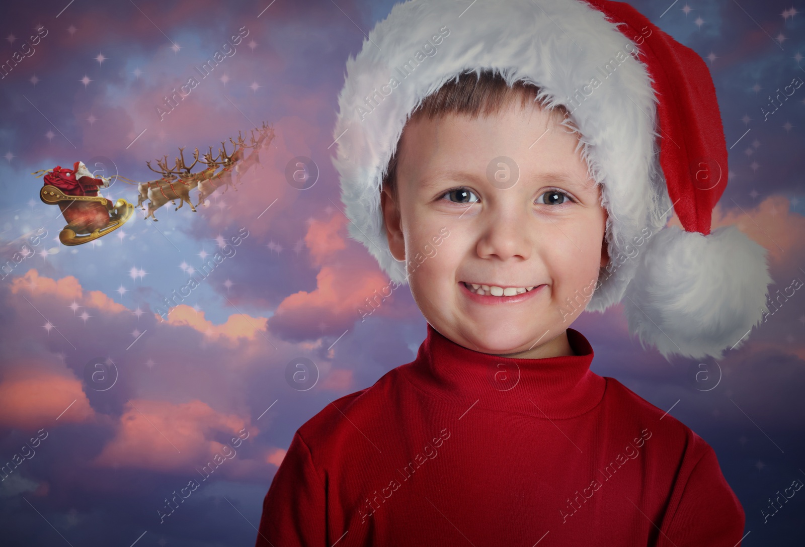 Image of Cute little child and Santa Claus flying in his sleigh on background. Christmas celebration