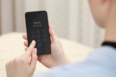 Woman unlocking smartphone with blocked screen indoors, closeup