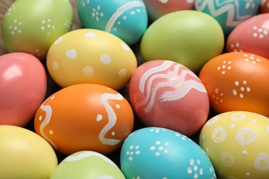 Photo of Many colorful painted Easter eggs as background, closeup