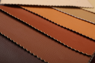 Photo of Different leather samples as background, closeup view