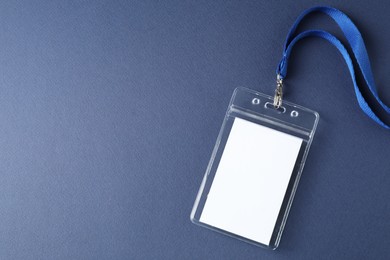 Photo of Blank badge with string on blue background, top view. Space for text