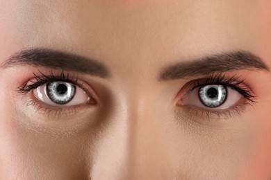 Beautiful woman with captivating grey eyes, closeup