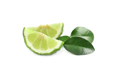 Slices of fresh ripe bergamot fruit and green leaves on white background