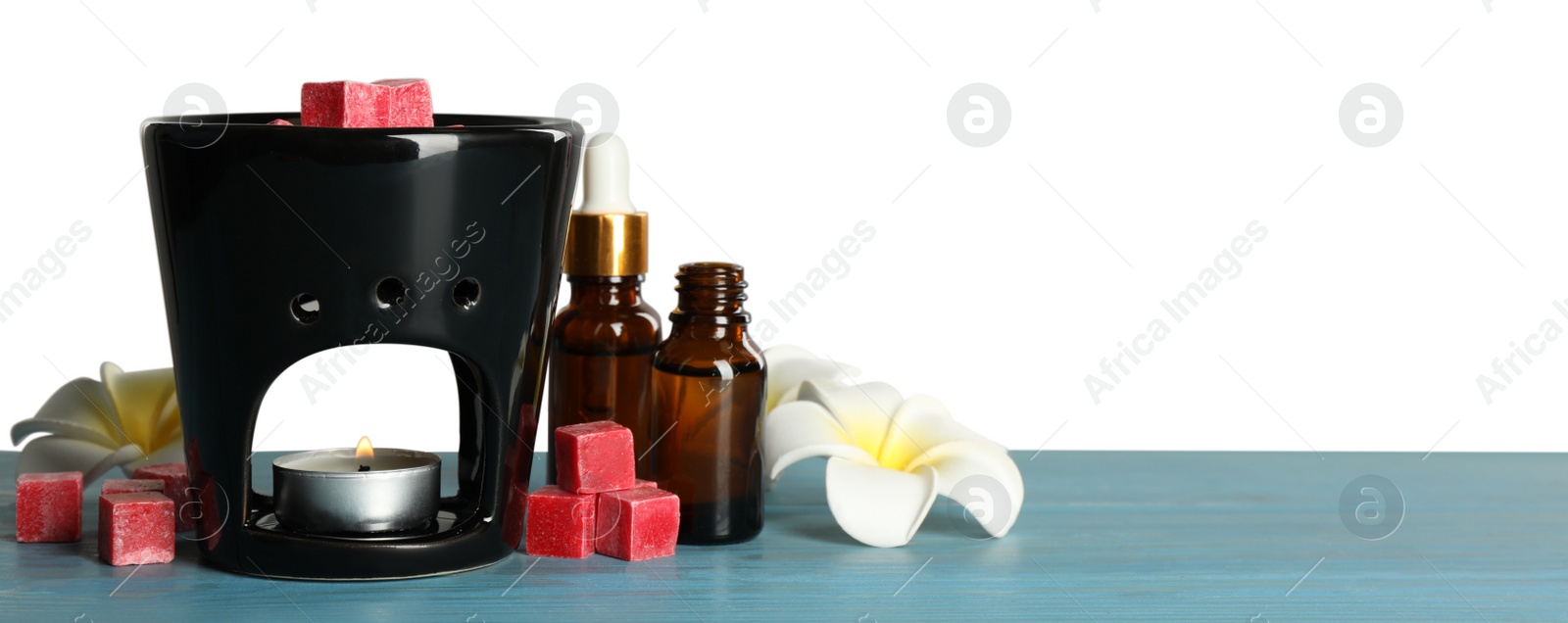 Photo of Composition with aroma lamp on blue wooden table against light grey background, space for text