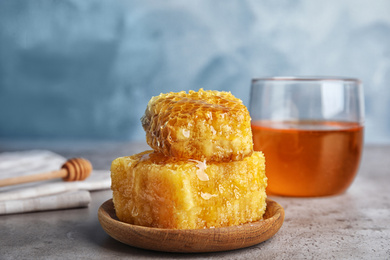 Fresh delicious honeycombs on grey table, closeup