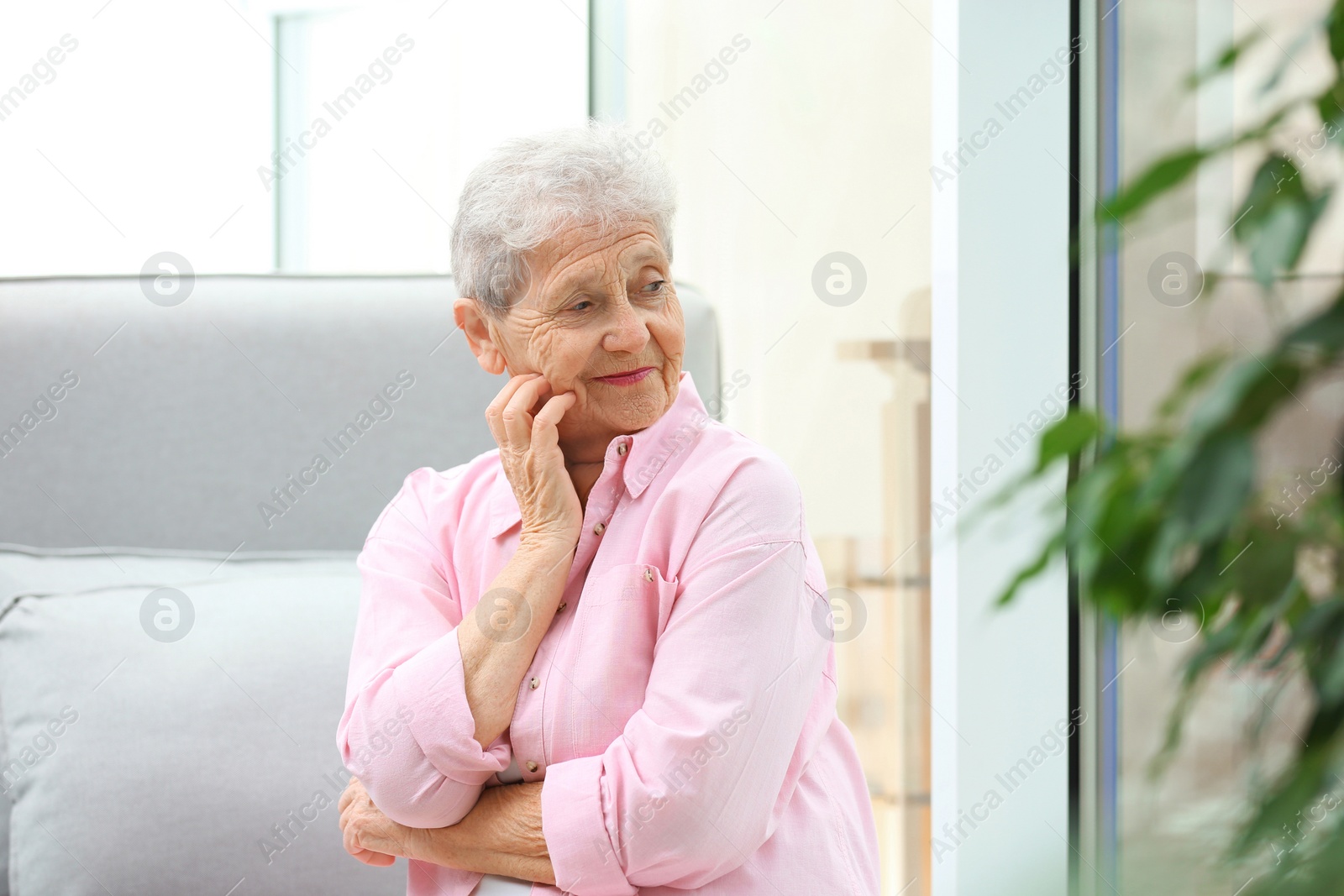 Photo of Portrait of beautiful grandmother in living room