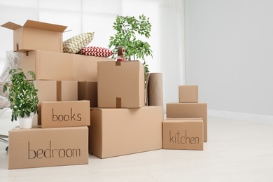 Photo of Pile of moving boxes in empty room