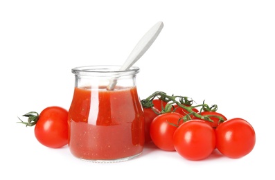Photo of Jar of sauce with spoon and tomatoes isolated on white