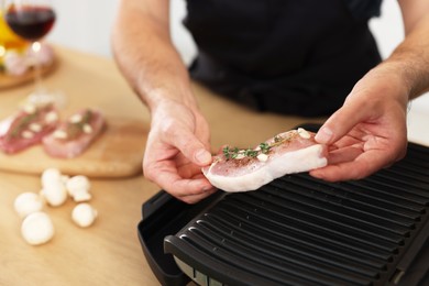 Photo of Man making dinner at table, closeup. Online cooking course