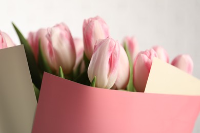 Beautiful bouquet of fresh pink tulips on blurred background, closeup