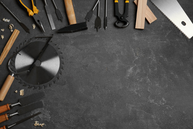 Photo of Flat lay composition with carpenter's tools on grey background. Space for text