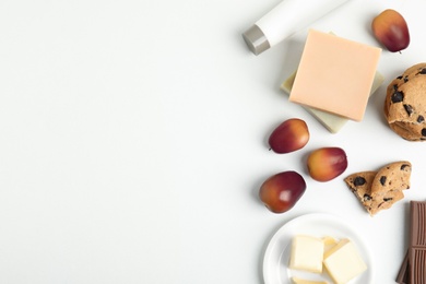 Composition with palm oil fruits on white table, top view