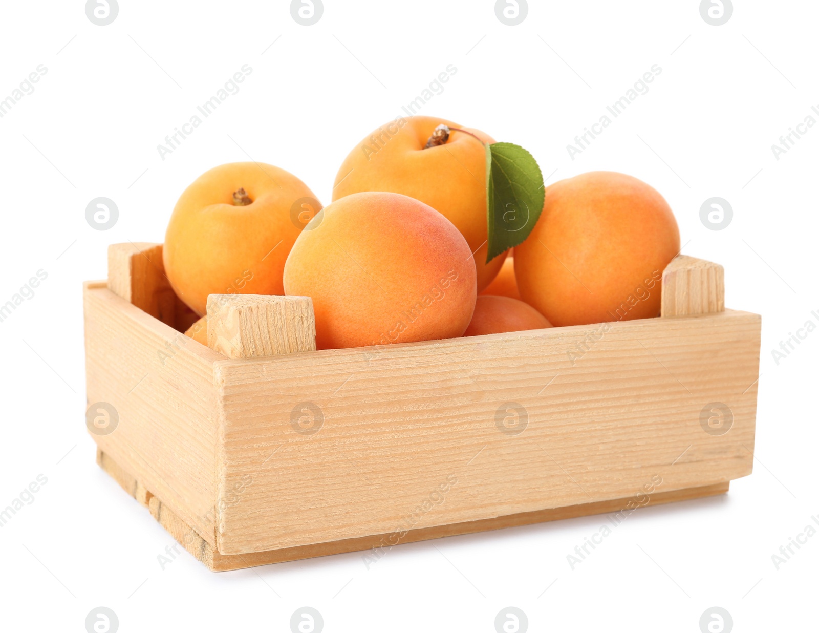 Photo of Wooden crate of delicious ripe sweet apricots isolated on white