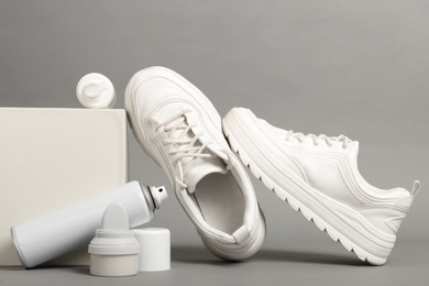 Photo of Composition with stylish footwear and shoe care accessories on grey background