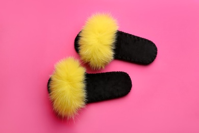 Photo of Pair of soft slippers on pink background, flat lay
