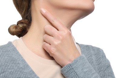 Woman suffering from sore throat on white background, closeup