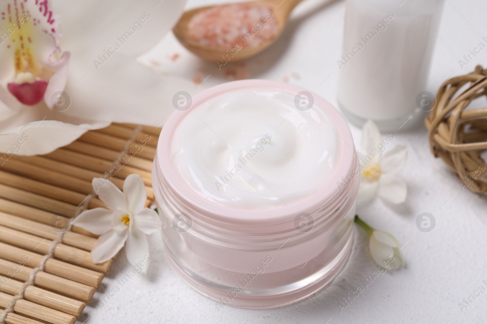 Photo of Beautiful spa composition with cosmetic products and flowers on white table