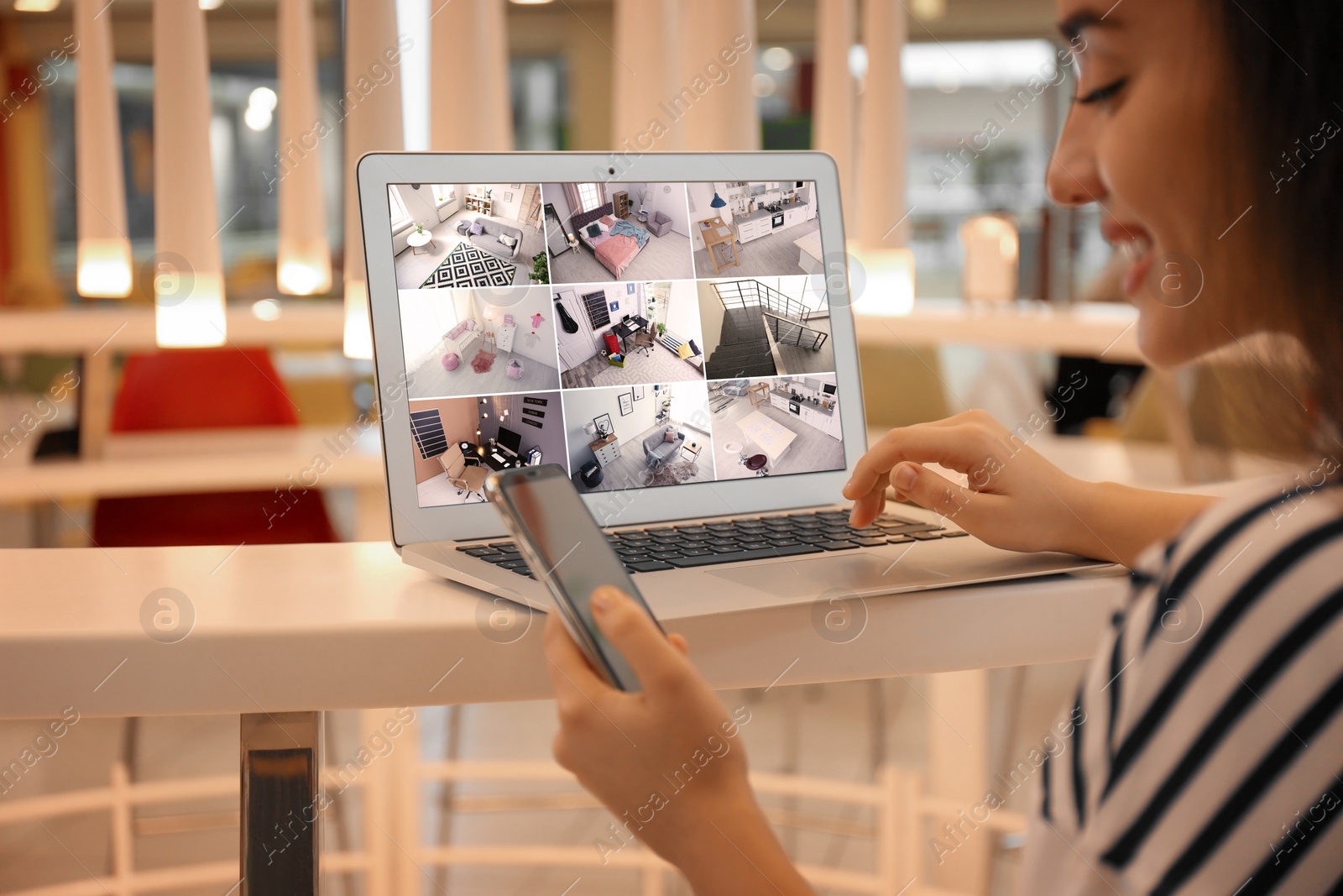 Image of Woman monitoring modern cctv cameras on laptop indoors, closeup. Home security system