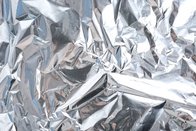 Crumpled silver foil as background, closeup view