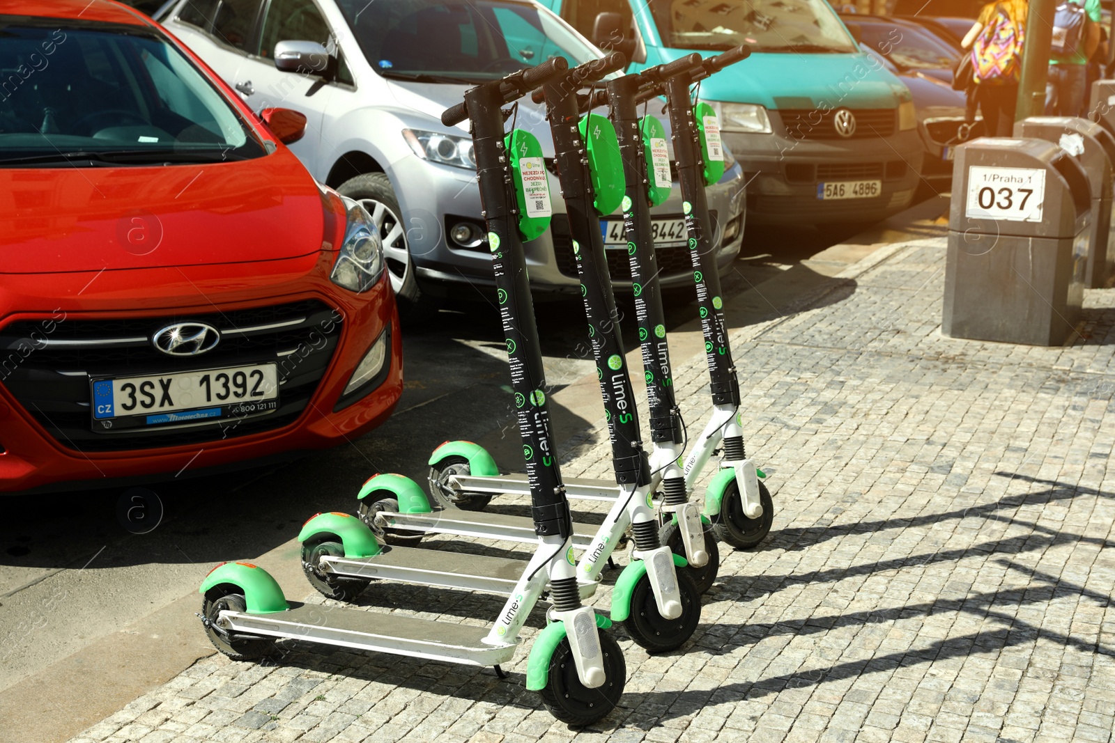 Photo of PRAGUE, CZECH REPUBLIC - APRIL 25, 2019: City street with scooters and cars on parking lot