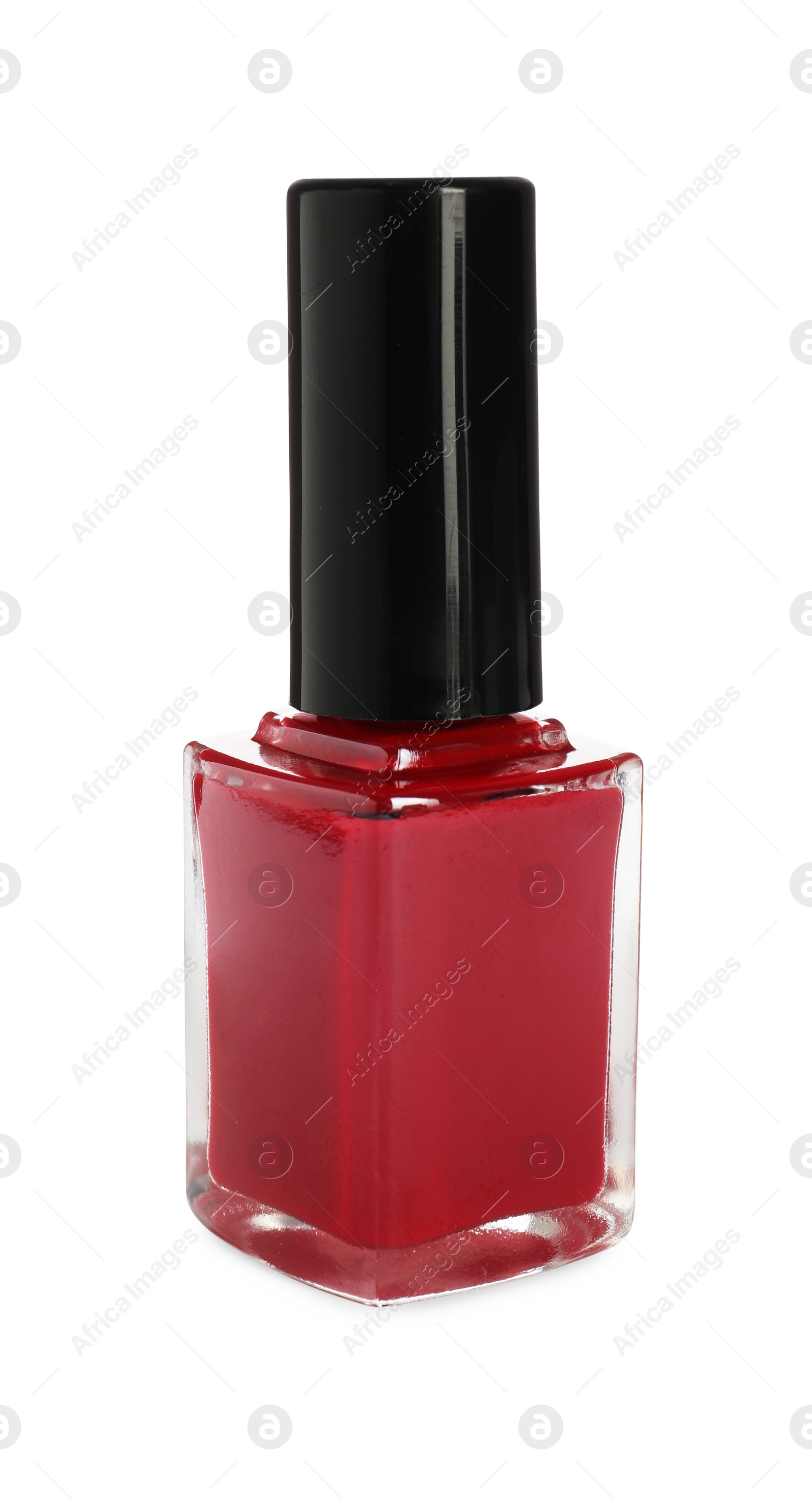 Photo of Red nail polish in bottle isolated on white