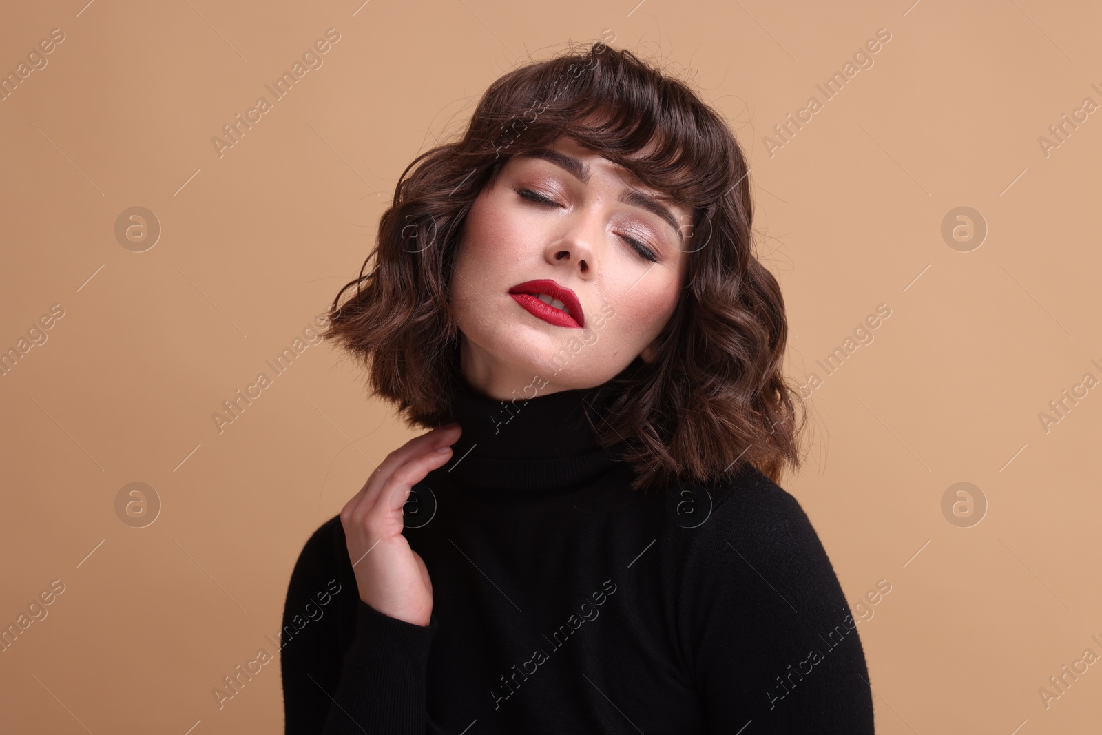 Photo of Portrait of beautiful young woman with wavy hairstyle on beige background