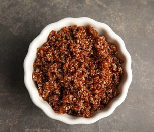 Cooked red quinoa in bowl on table, top view