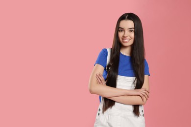 Photo of Portrait of teenage girl on pink background. Space for text