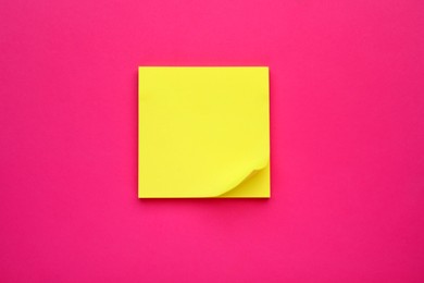 Photo of Yellow empty notes on pink background, top view