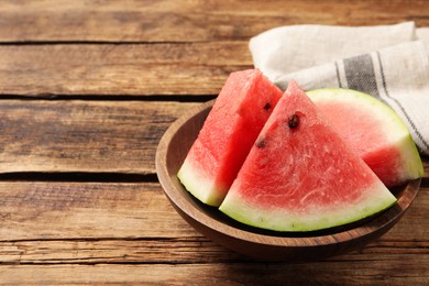 Photo of Delicious fresh watermelon slices on wooden table. Space for text