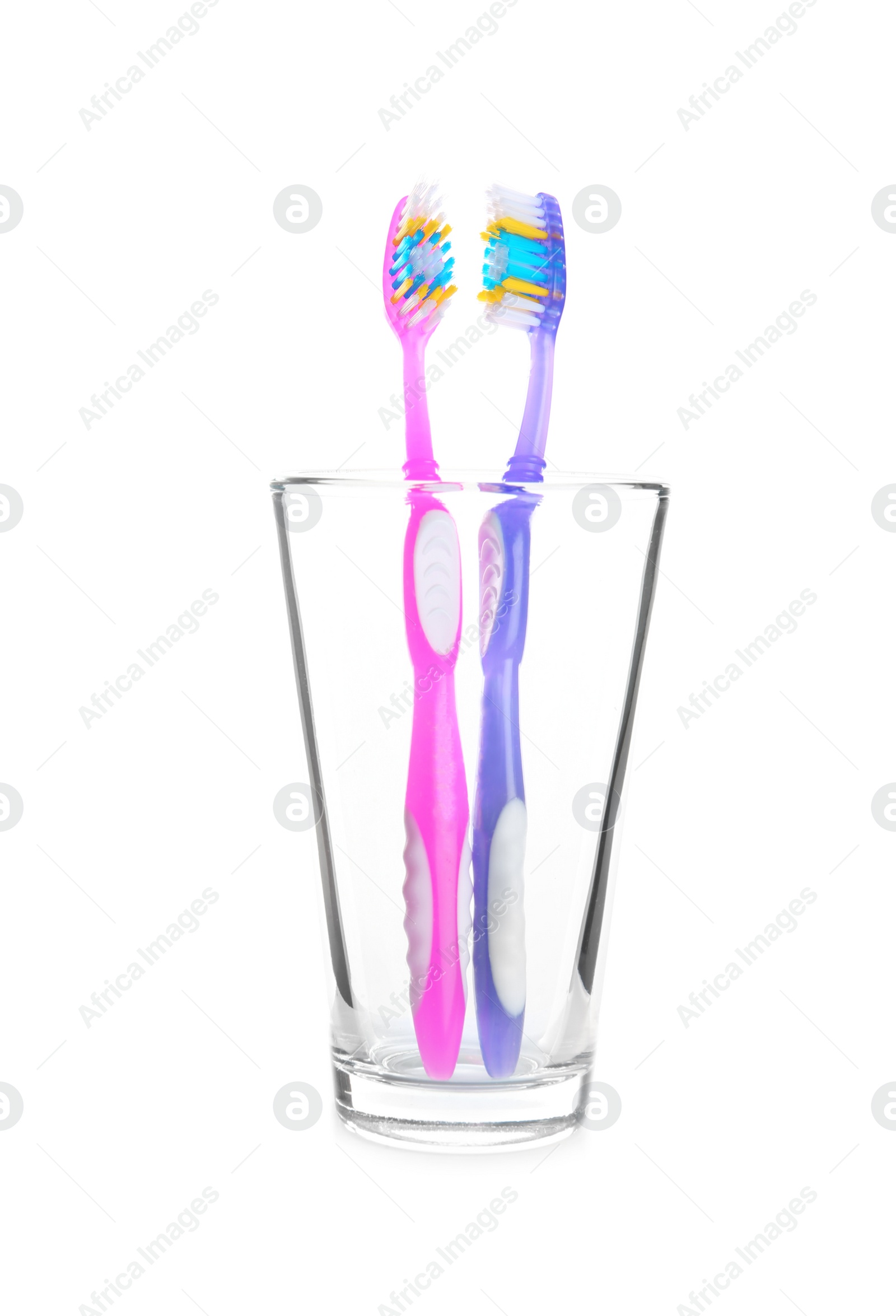 Photo of Cup with toothbrushes on white background. Dental care