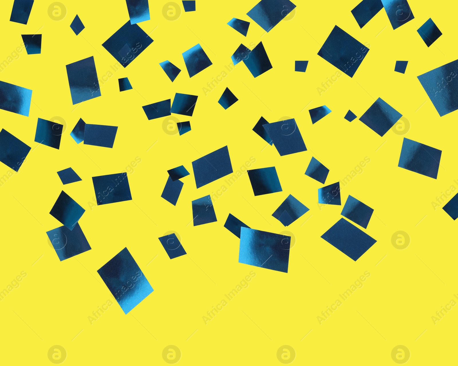 Image of Shiny blue confetti falling on yellow background